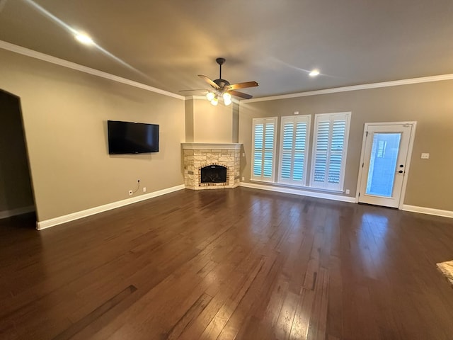 unfurnished living room featuring ornamental molding, a fireplace, dark wood finished floors, and baseboards