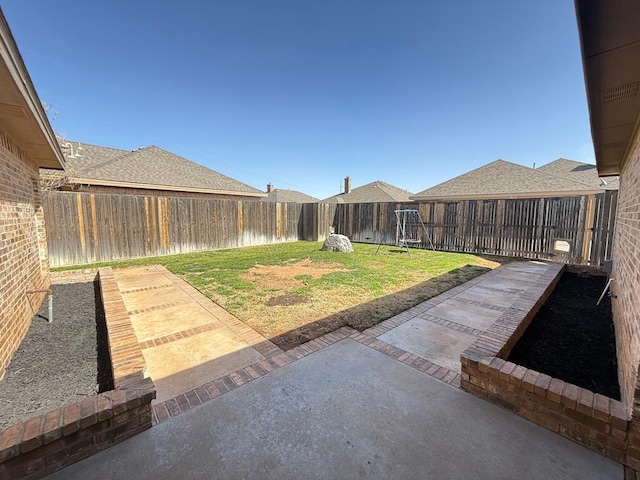 view of yard with a patio area and a fenced backyard