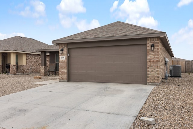 view of front of property with cooling unit and a garage