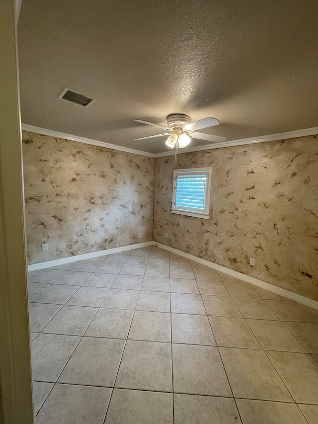 tiled spare room featuring ceiling fan, crown molding, and a textured ceiling