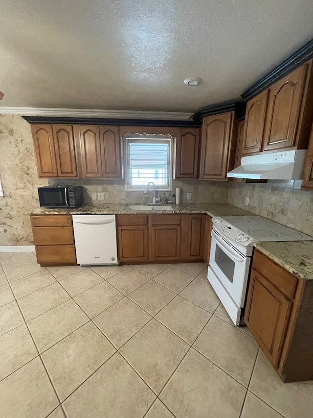 kitchen with light tile patterned floors, white appliances, backsplash, and sink