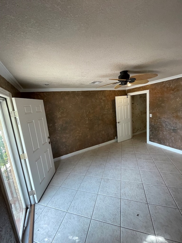 interior space with ceiling fan, ornamental molding, and a textured ceiling