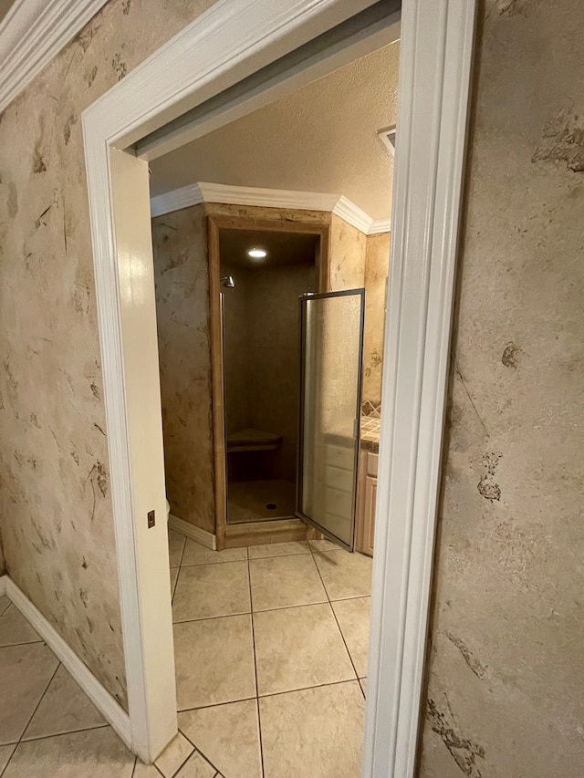 bathroom with tile patterned floors, crown molding, and a textured ceiling