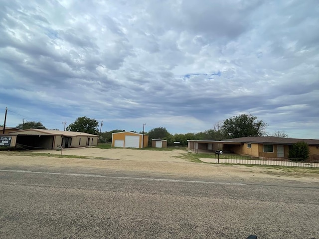 view of front of property featuring an outdoor structure and a garage