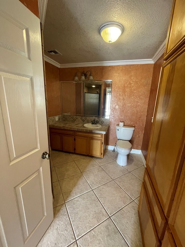 bathroom featuring vanity, tile patterned floors, crown molding, toilet, and tasteful backsplash