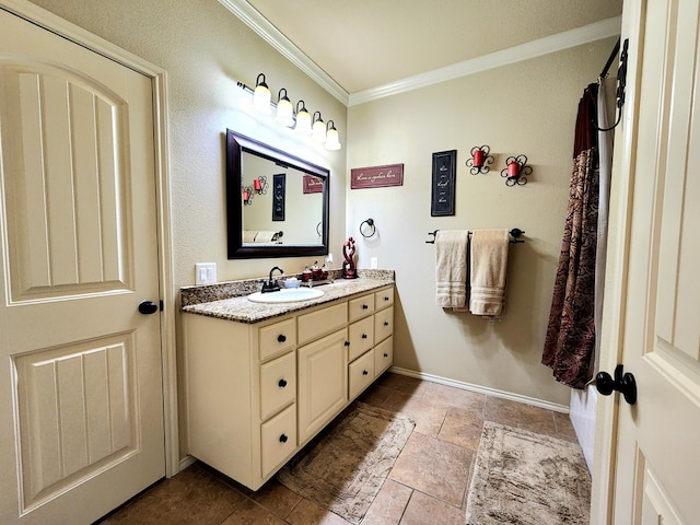 bathroom featuring crown molding and vanity