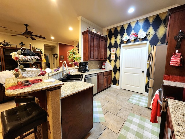 kitchen with sink, a breakfast bar area, appliances with stainless steel finishes, ornamental molding, and kitchen peninsula