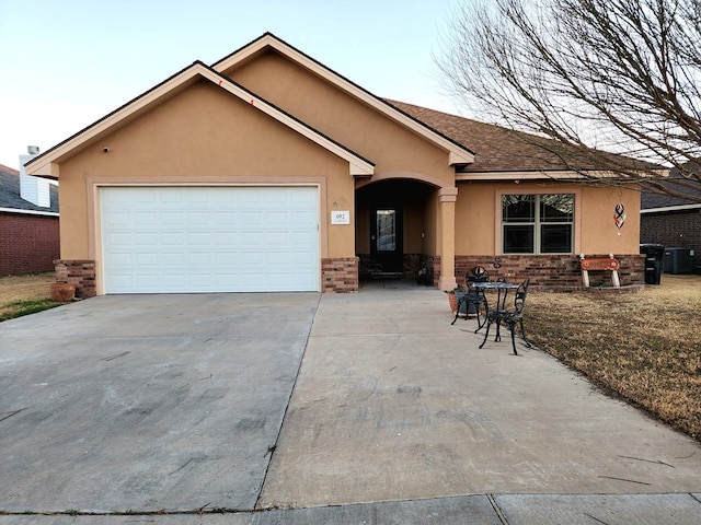 single story home featuring a garage and central AC