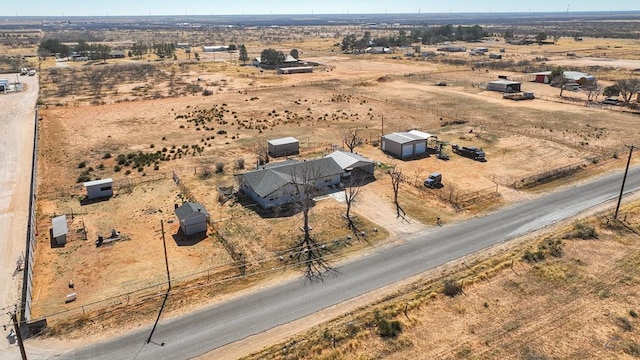 birds eye view of property with view of desert and a rural view