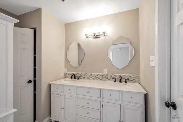 bathroom featuring double vanity, a sink, and decorative backsplash