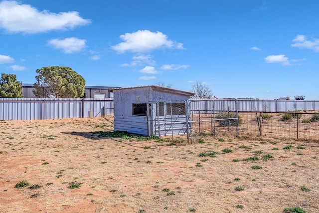 exterior space with an outbuilding and fence