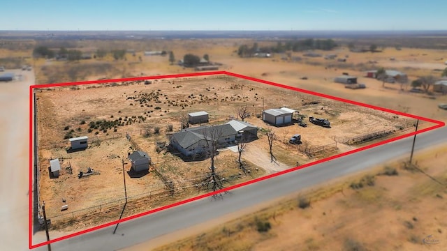 drone / aerial view featuring view of desert and a rural view