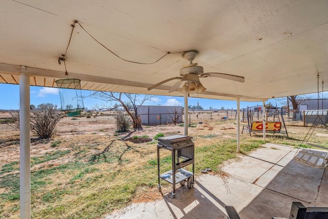 view of patio with fence and a ceiling fan