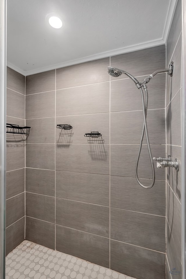 full bath featuring a shower stall and crown molding