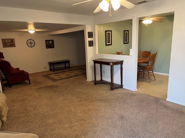 living room featuring ceiling fan and light colored carpet