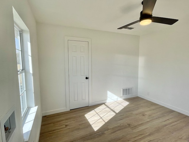 spare room with light hardwood / wood-style floors and ceiling fan