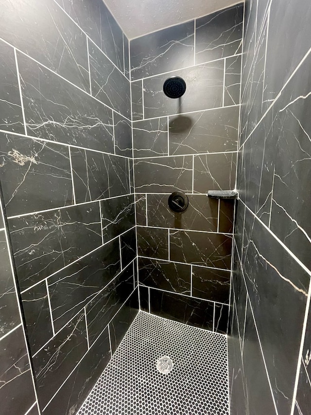 bathroom with a tile shower