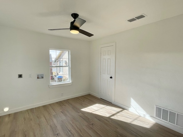 unfurnished room featuring ceiling fan and light wood-type flooring