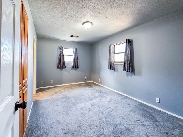 unfurnished room with baseboards, carpet floors, and a healthy amount of sunlight