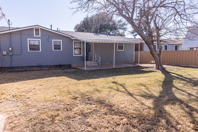 back of property featuring a yard, fence, and a patio