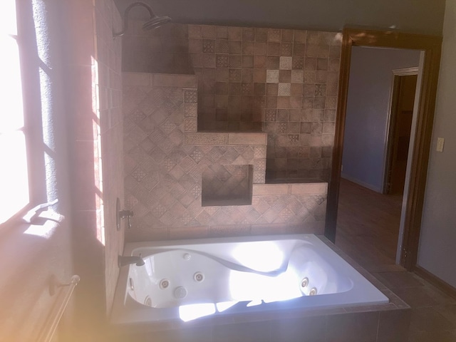 bathroom featuring a shower and a jetted tub