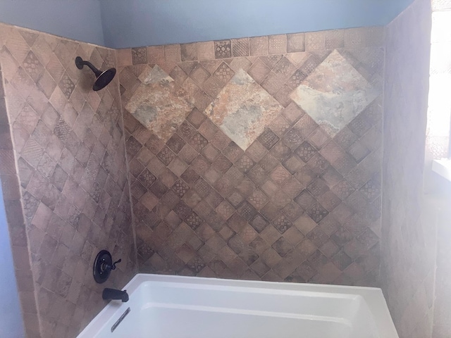 room details featuring shower / bathtub combination