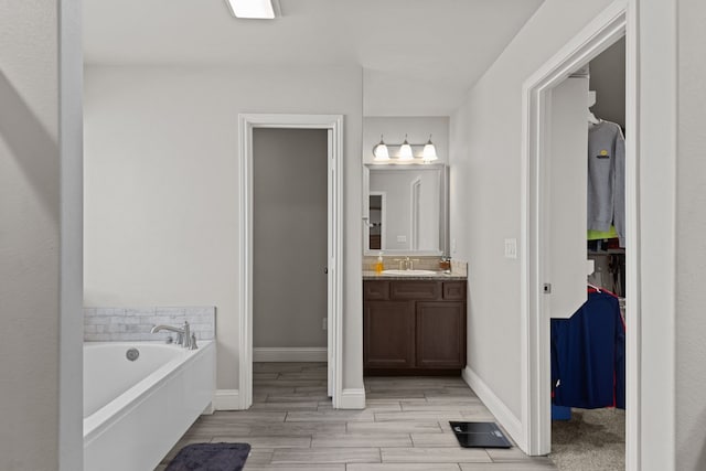 bathroom with a bath and vanity