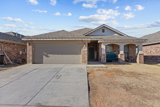 ranch-style house with covered porch and a garage