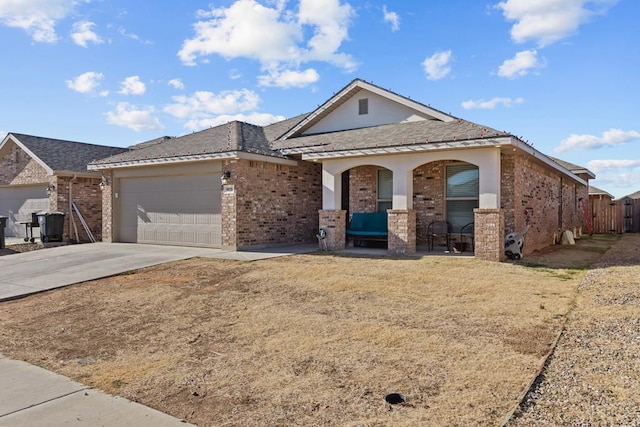 ranch-style home featuring covered porch and a garage