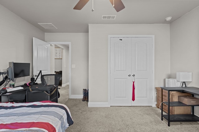 carpeted bedroom with ceiling fan and a closet