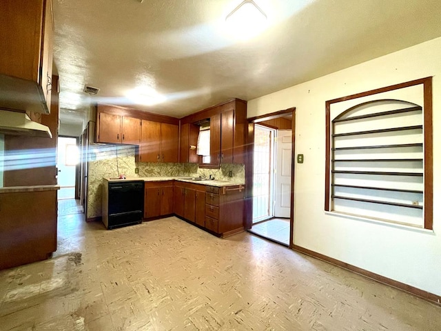 kitchen featuring decorative backsplash, dishwasher, and sink