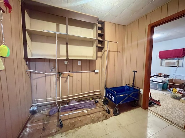 exercise room featuring carpet floors, cooling unit, and wooden walls