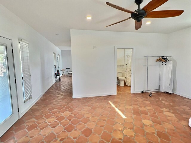 unfurnished room featuring a wealth of natural light and ceiling fan