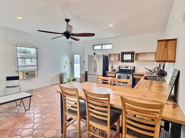 dining room with ceiling fan, sink, cooling unit, and light tile patterned floors