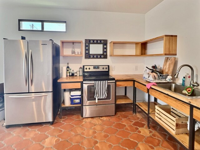 kitchen featuring tile patterned flooring, sink, and stainless steel appliances