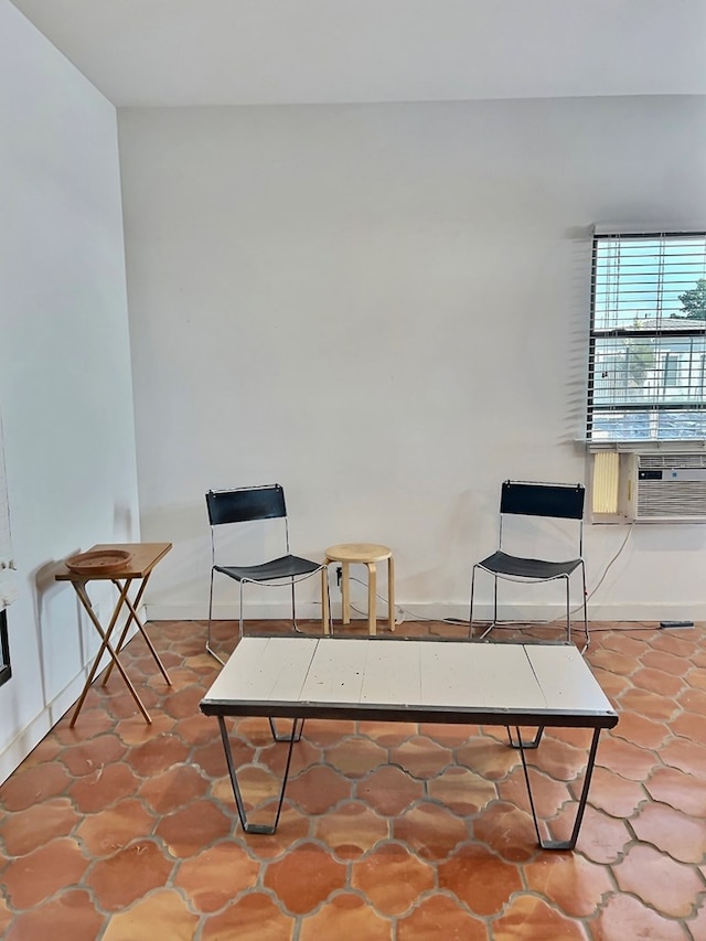 living area with tile patterned floors and cooling unit