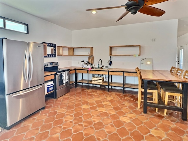 kitchen featuring ceiling fan, sink, and appliances with stainless steel finishes