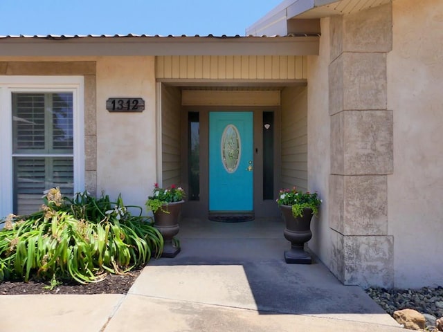 doorway to property with metal roof