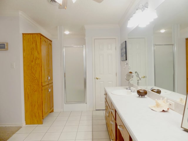 full bathroom featuring ornamental molding, tile patterned flooring, a shower stall, and vanity