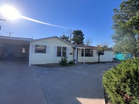 single story home featuring a carport