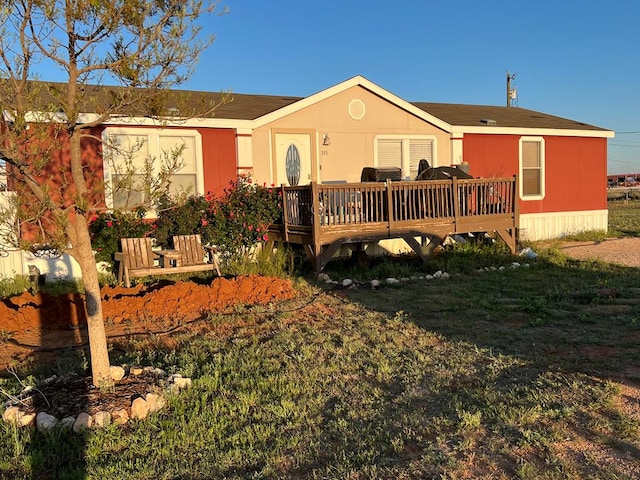 back of house with a wooden deck