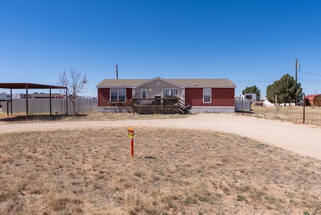 manufactured / mobile home with driveway and fence