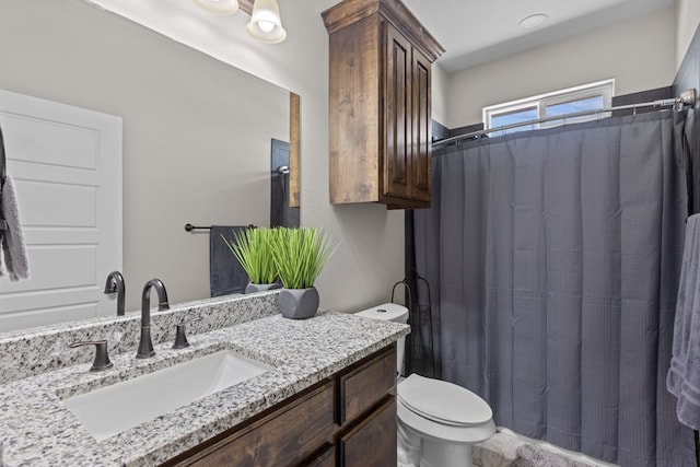 bathroom with toilet and vanity