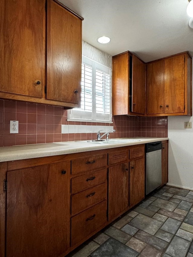 kitchen with dishwasher, backsplash, and sink