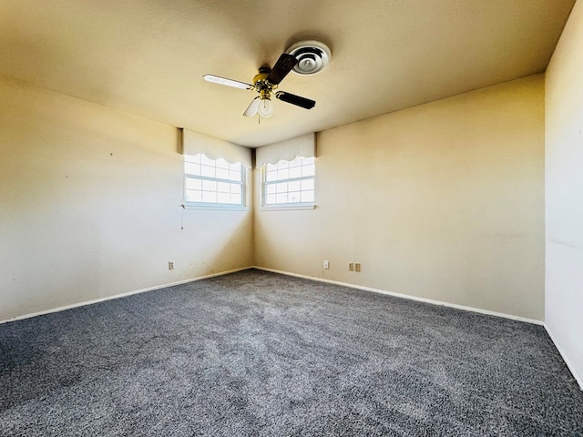 empty room featuring ceiling fan and carpet floors