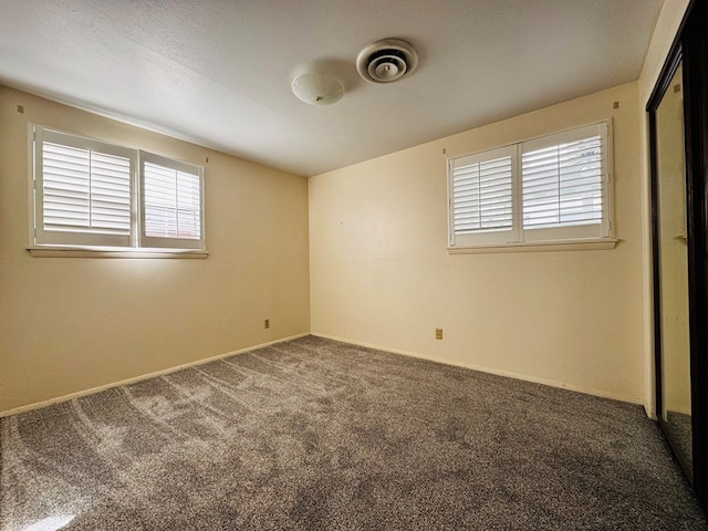 unfurnished room featuring carpet