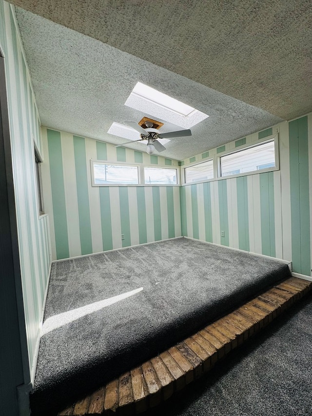 unfurnished sunroom featuring ceiling fan