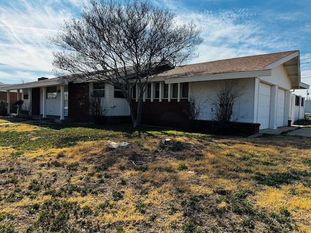 exterior space featuring a front lawn and a garage