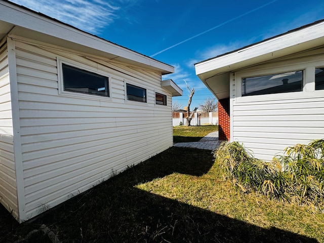 view of side of home featuring a lawn