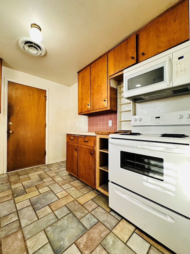 kitchen with white appliances and decorative backsplash